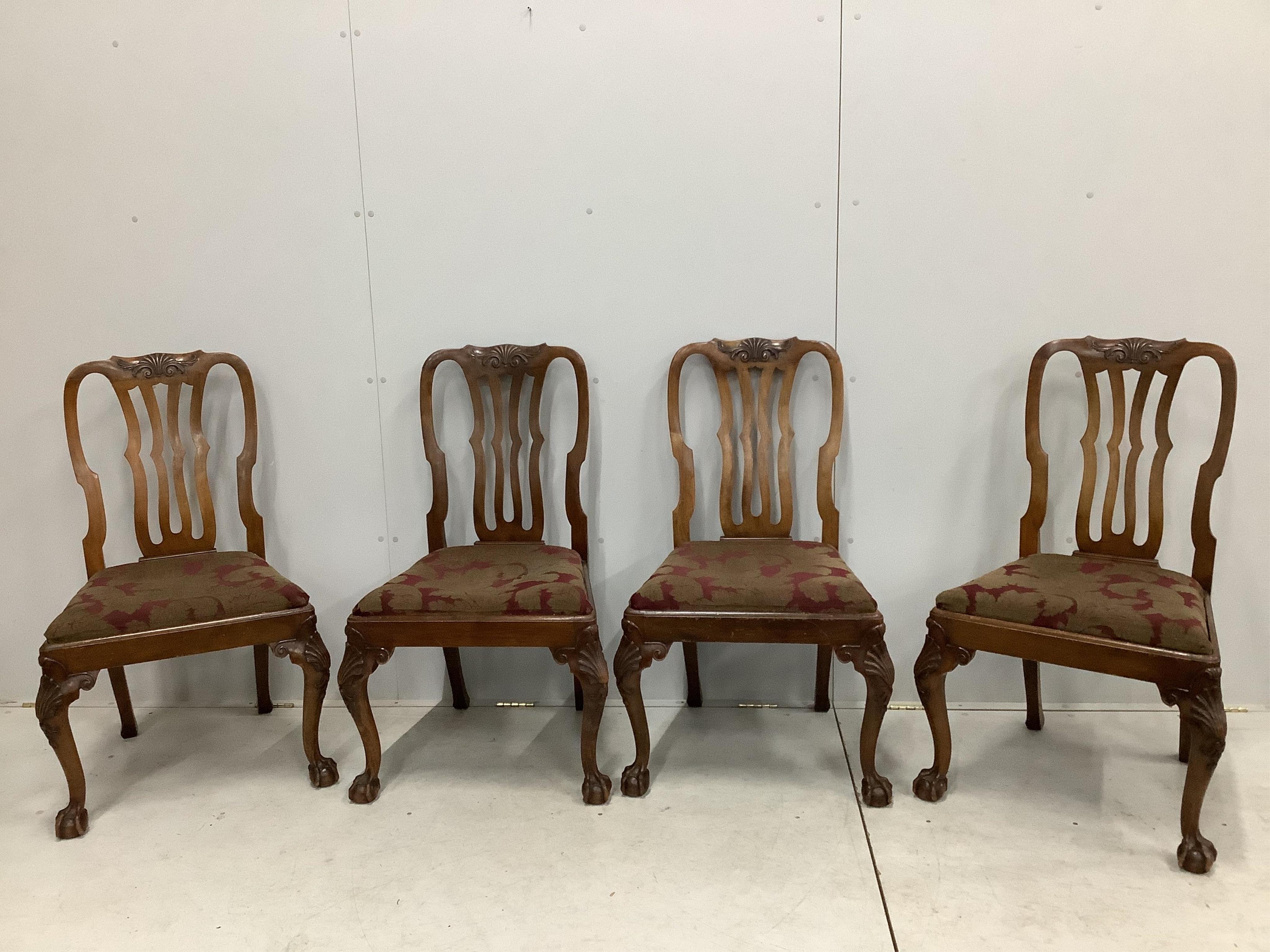 A set of eight George II style mahogany dining chairs on cabriole legs and ball and claw feet, two with arms. Condition - fair